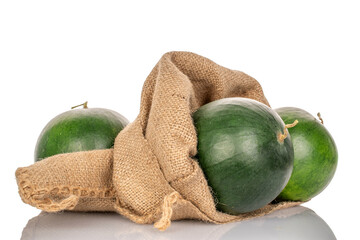 Three sweet watermelons with jute bag isolated on white background, macro.