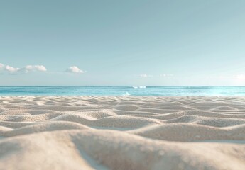 empty sandy beach with a blue sky and ocean in the background