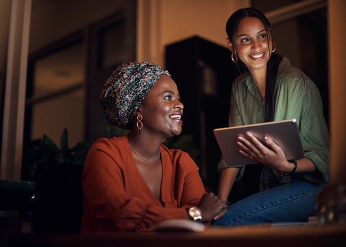 Business women, working late and collaboration in office with pointing at computer screen. Female people, partner and teamwork for deadline, project or editing as online content creator for diversity