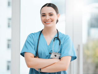 Portrait, happy woman and surgeon with arms crossed for healthcare services, career or medicine in hospital. Proud, medical professional and confident physician with smile at clinic ready for surgery