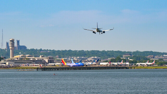 Washington DC, USA - 1 May 2024: Passenger plane landing at Ronald Reagona National Airport on the banks of the Potomac River in Washington DC.