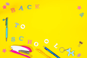 A yellow background with school supplies and the words back to school written on it