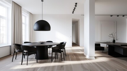 Modern minimalist living room with dark chairs, a black round table, white walls, and large windows. Open and bright