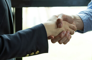 Business people shaking hands, finishing up a meeting, after successful deal.