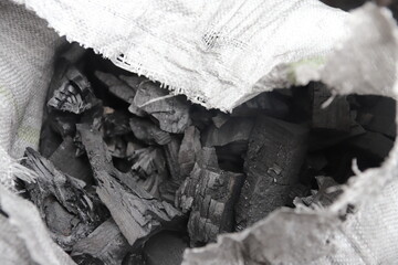 ready-made pieces of charcoal in a bag burned out in the Bieszczady Mountains in Szczerbanówka, black and white photo