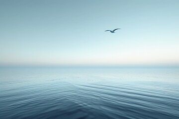 Naklejka premium A serene and calm ocean landscape with a single bird gracefully flying above the gentle waves under a clear blue sky, capturing a moment of tranquility and freedom.