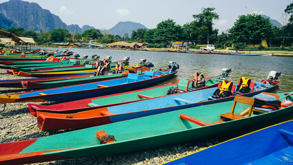 Traditional Long tail boats in Nam Song river at Vang Vieng, Laos. Tourist boats at Vang Vieng (a tourist-oriented town in Laos in Vientiane Province)