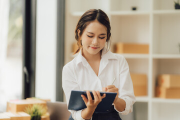 Asian female entrepreneurs, small business startups, SME owners, who prepare boxes to sell to SME customers with online business ideas.