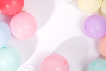 A variety of colorful balloons against a bright white backdrop for a festive atmosphere