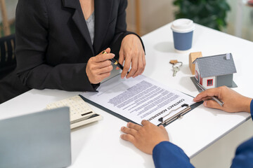 Sale representative offer house purchase contract to buy a house or apartment or discussing about loans and interest rates