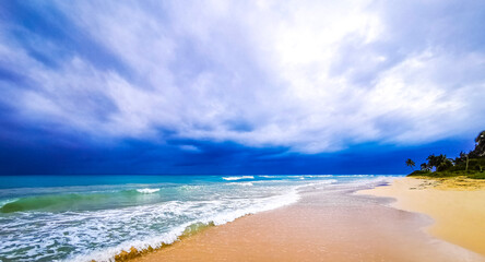 Tropical Caribbean beach people parasols fun Playa del Carmen Mexico.