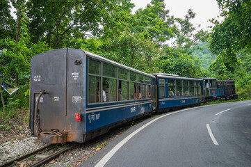 Darjeeling,West Bengal,India - 10th August 2023 : Diesel Toy train passing through Himalayan roads...