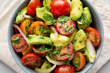 Homemade Avocado And Tomato Salad in a Bowl, top view.