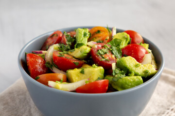 Homemade Avocado And Tomato Salad in a Bowl, side view.