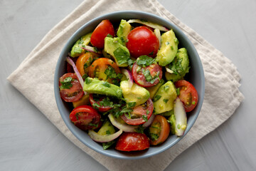 Homemade Avocado And Tomato Salad in a Bowl, top view. Flat lay, overhead, from above.