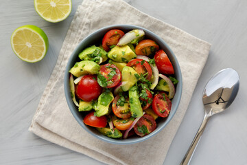 Homemade Avocado And Tomato Salad in a Bowl, top view. Flat lay, overhead, from above.