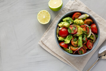 Homemade Avocado And Tomato Salad in a Bowl, top view. Flat lay, overhead, from above.