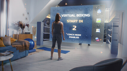 Female athlete wearing augmented reality headset starts boxing training. VR screen shows virtual coach and interface of AR boxing app. Metaverse futuristic home gym with AI technologies. VFX animation