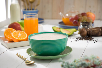 Oatmeal, healthy food item  arranged on wooden background in a ceramic bowl.