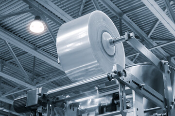 Automatic polyethylene plastic bag production machine with lighting effect. Close-up of the roller...