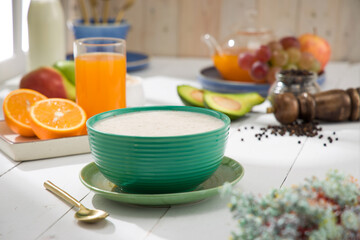 Oatmeal, healthy food item  arranged on wooden background in a ceramic bowl.