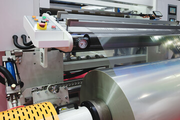 Automatic polyethylene plastic bag production machine with lighting effect. Close-up of the roller...