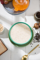 Oatmeal, healthy food item  arranged on wooden background in a ceramic bowl.