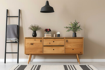 Vase with lilacs on wooden chest of drawers, ladder and lamp in stylish room
