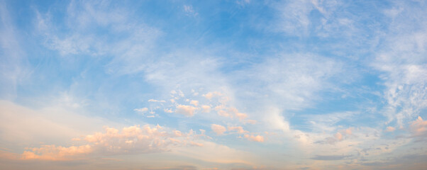A beautiful blue sky with pink clouds. The sky is a perfect backdrop for a beautiful sunset