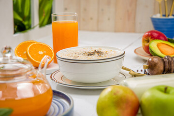 Oatmeal, healthy food item  arranged on wooden background in a ceramic bowl.