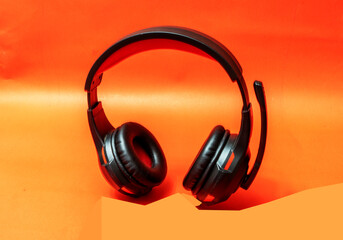 Wireless Over-Ear full size Headphones, Black leather isolated on red background with clipping path.