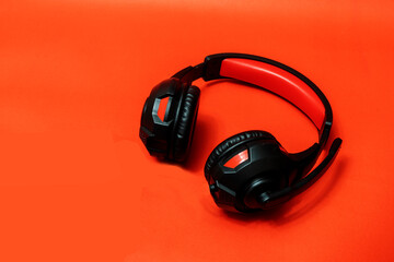 Wireless Over-Ear full size Headphones, Black leather isolated on red background with clipping path.
