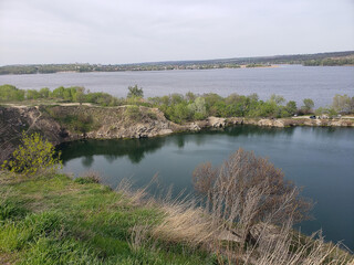river and lake among vegetation under a blue sky