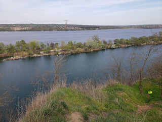 river and lake among vegetation under a blue sky