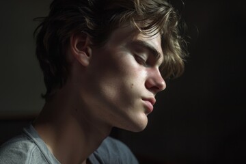 Contemplative Young Man in Dim Lighting