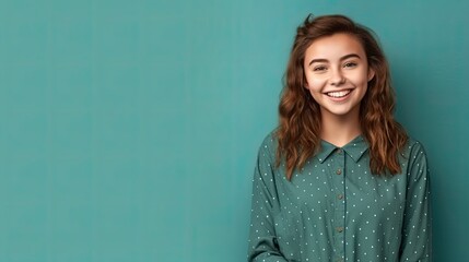 Obraz premium cheerful young young girl in clothes, simple teal background color for copy text space, wide screen for ads and banners