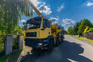 A concrete mixer feeds concrete into the screed when building a house