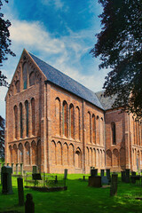 Fototapeta premium The impressive nave of the cruciform Romano-Gothic St. Peter’s church (Petruskerk, 15th century), surrounded by an old cemetery, in Zuidbroek, province of Groningen, the Netherlands 