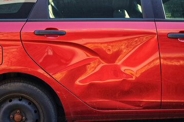 Car dented rear door from collision. Dented door of car after accident, collision impact on...