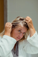 Woman applies oil to her hair with massage. Beauty caring for scalp and hair. 