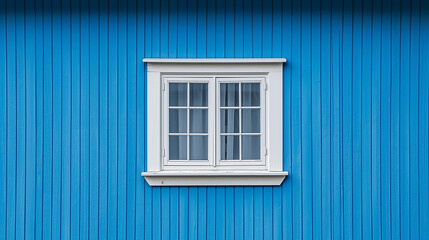 Fototapeta premium A vibrant blue wall with vertical ridges. Positioned centrally on this wall is a white window with six panes. The window has a white frame and appears to be slightly ajar