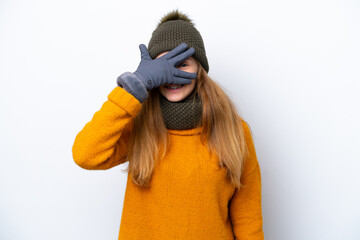 Teenager Russian girl wearing winter jacket isolated on white background covering eyes by hands and smiling