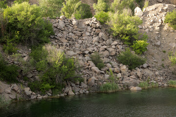 Rocky shore of a quarry lake