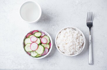 Cucumber and radish salad in a bowl with rice
