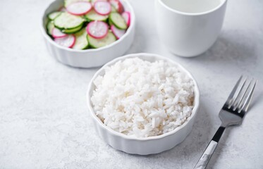 Rice with cucumber and radish salad in a bowl