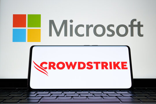 CrowdStrike and Microsoft logo seen on screen of smartphone and laptop. Cybersecurity company behind the global IT outage. Stafford, United Kingdom, July 19, 2024