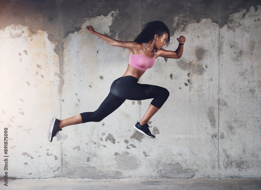 Wall mural Sports, running and woman with speed in city for workout, marathon training or endurance challenge. Fitness, wellness and hispanic athlete with jump for morning cardio, energy or race in urban town