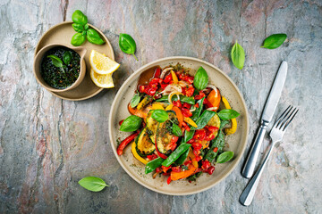 French style summer ratatouille salad with roasted vegetables served as top view with vinaigrette balsamic dressing on a design plate