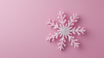 Minimalistic Christmas concept with isolated snowflake decoration on pastel pink backdrop