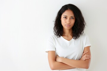 Serene Woman with Arms Crossed in Minimalist Setting